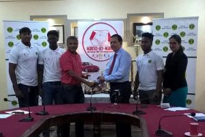 Honorary Secretary of the GCB, Anand Sanasie (third from left) receives the sponsorship cheque from Director of Hand-In-Hand, Cecil Cox in the presence of the three West Indies Under-19 Guyanese players and Business Development Officer, Savita Singh (extreme right).
