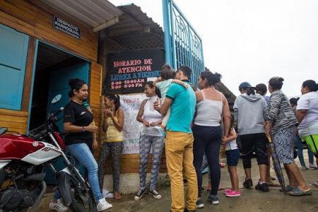 People line up outside the Centro Piloto office seeking information about school enrollment for undocumented Venezuelan children in Cúcuta, Colombia on April 4, 2018.