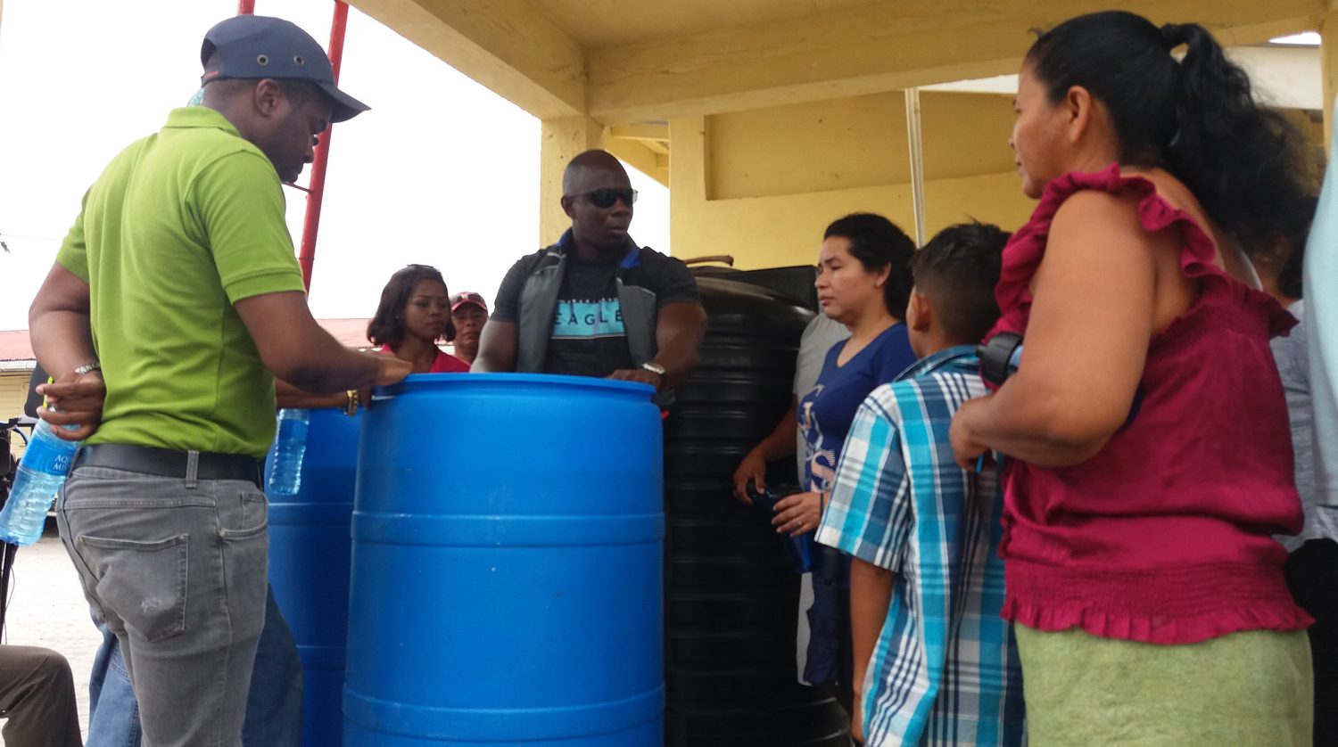 GWI’s Operations Director, Dwayne Shako  (centre) explains the Slow Sand Filtration system to residents of Wakapoa. (GWI photo)
