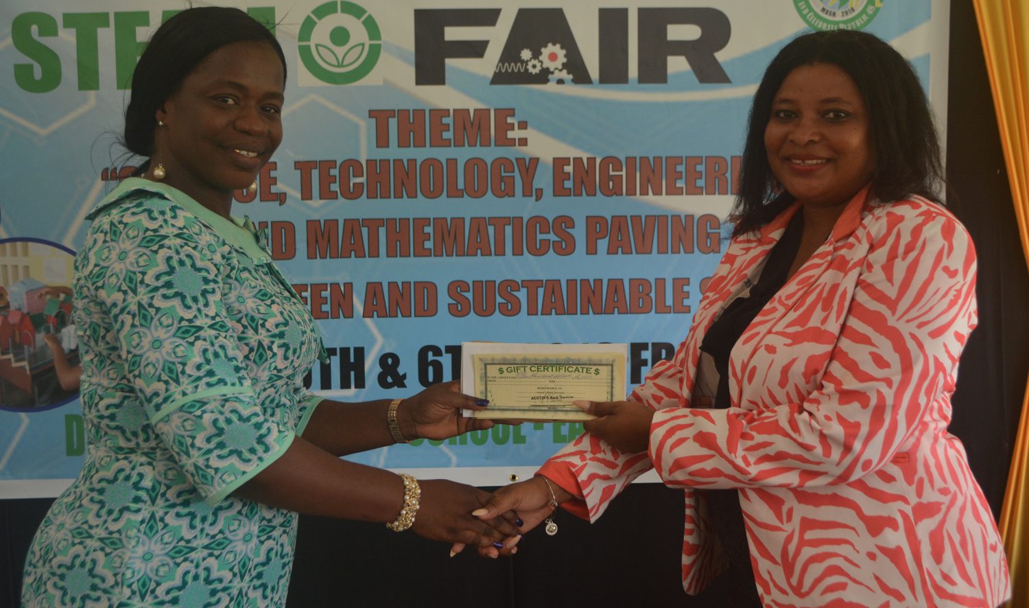 Shevion Sears (right), Public Relations Officer of Guyana Power and Light presenting a cheque to Regional Education Officer ag Tiffany Favourite Harvey. 