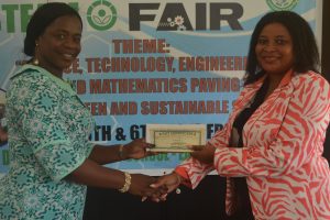 Shevion Sears (right), Public Relations Officer of Guyana Power and Light presenting a cheque to Regional Education Officer ag Tiffany Favourite Harvey. 