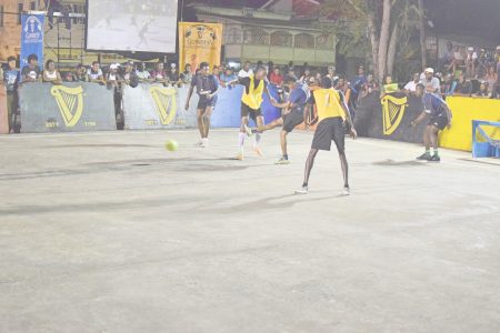 Clarence Huggins (centre) of Wisroc completing a crunching tackle on Damion Williams (yellow) of Silver Bullets, at the Silvercity Hard-court in the Guinness ‘Greatest of the Streets’ Linden edition. 