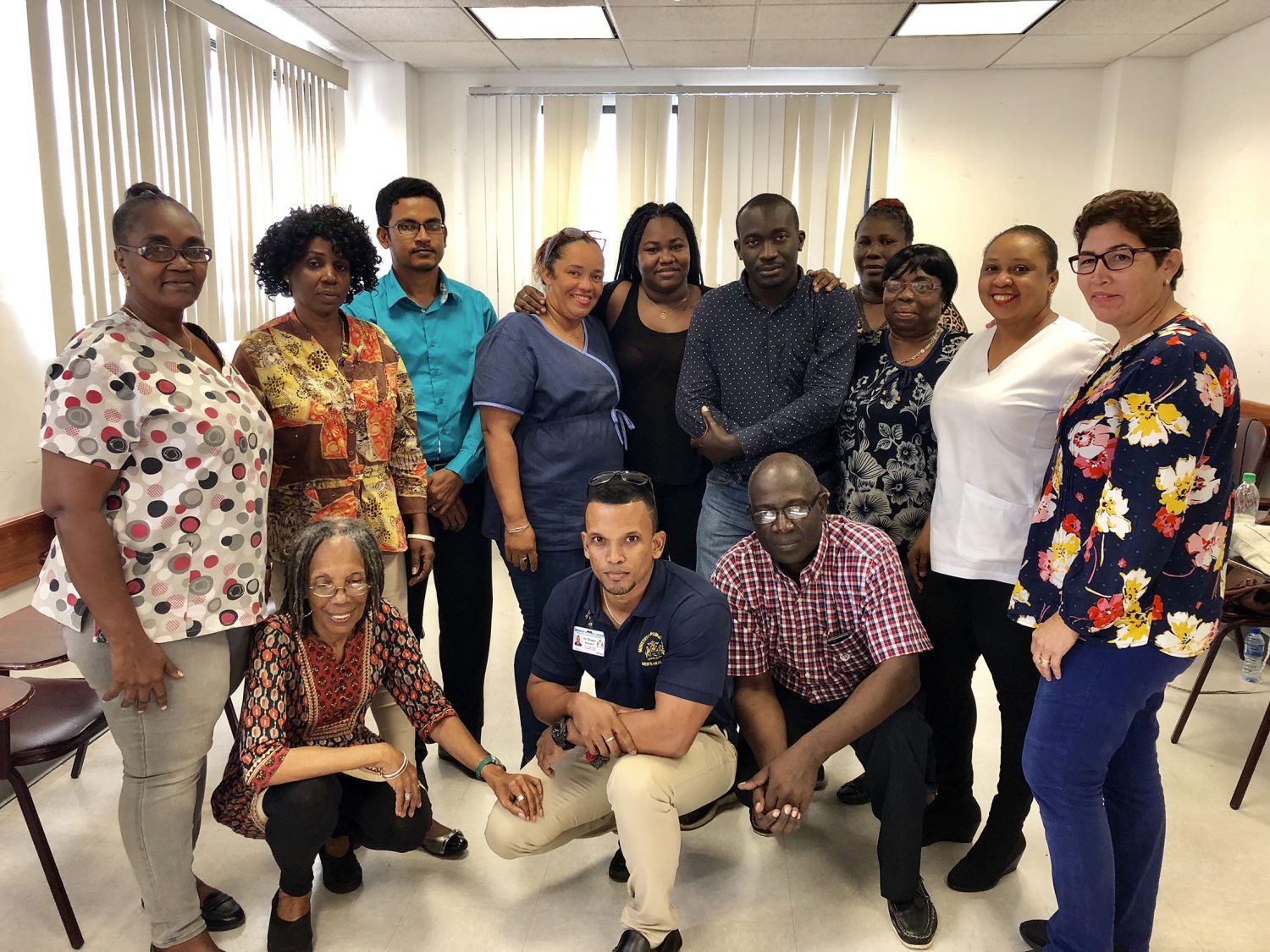 Stooping (from left) are Bonita Harris and Dr Dennis Bassier with participants at the workshop (MoPH photo)