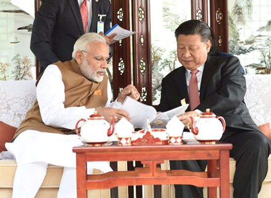 India’s Prime Minister Narendra Modi (left) speaks with Chinese President Xi Jinping (Reuters photo)
