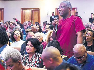 A member of the audience asks Prime Minister Dr Keith Rowley a question during yesterday’s meeting.
