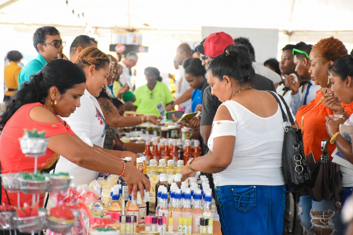 Patrons engaging with exhibitors at the UncappeD Marketplace & Food Festival yesterday at the Providence Stadium (DPI photo) 