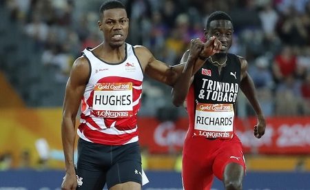 Trinidadian Jereem Richards (right) clashes arms across lanes with Zharnel Hughes in the dying stages of a frenetic 200 metres on Thursday. 
