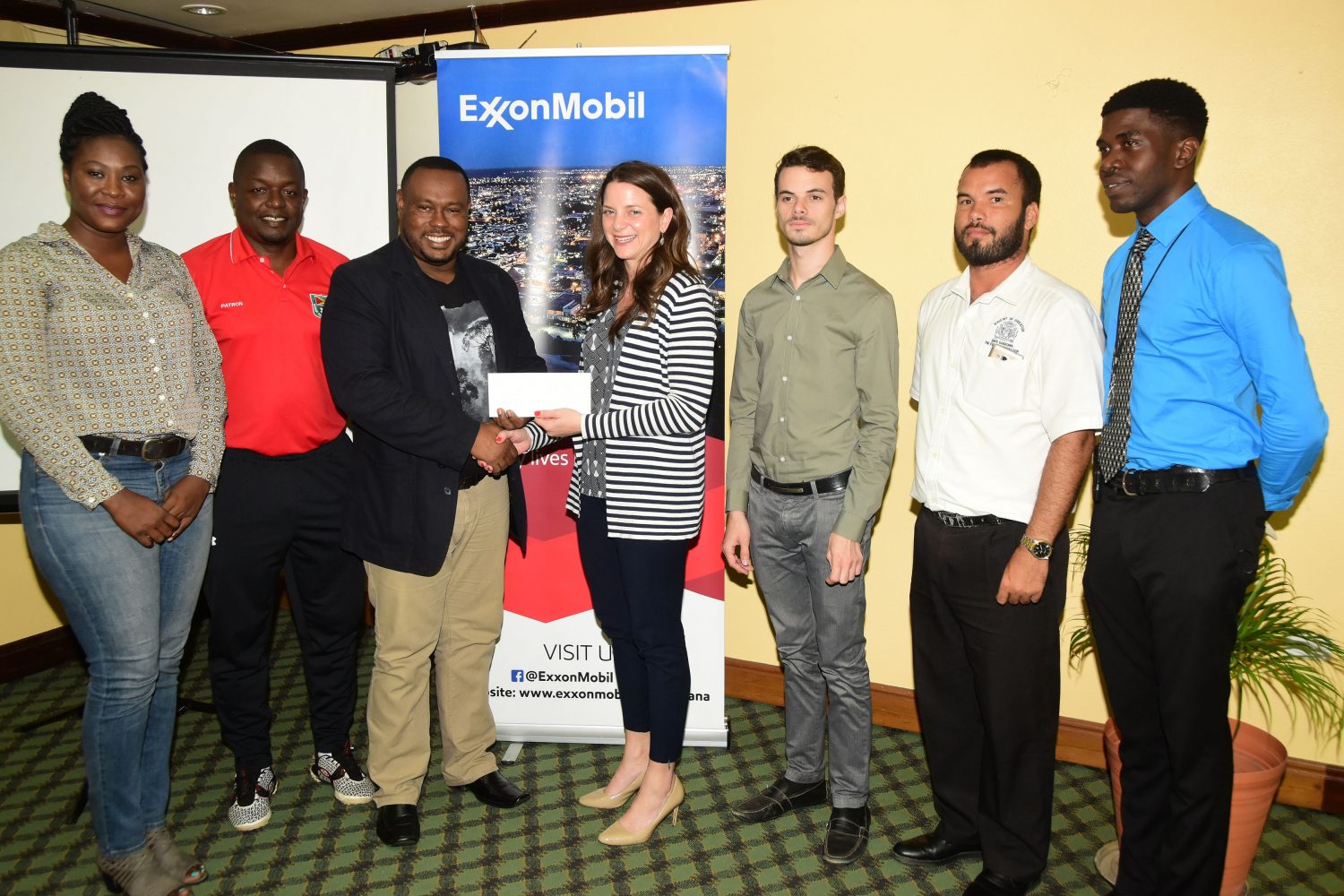 Petra Co-Director Troy Mendonca (third from left) receiving the sponsorship cheque from ExxonMobil Senior Director, Public and Government Affairs Kimberly Brassington (centre). Also in the photo, from left; Petra Co-coordinator Jacquline Boodie, GFF TDO Bryan Joseph, ExxonMobil Communications Advisor, Public and Government Affairs, Nicholas Yearwood, Ministry of Education, Allied Arts Programme Head, Nicholas Fraser, and Mark Alleyne of Petra.