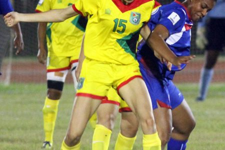 Lady Jaguars goal-scorer Brianne Desa (left) tussling with a Bermudian player for possession of the ball during their group-E clash in the CONCACAF Women’s Qualifiers at the National Track and Field Centre, Leonora
