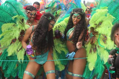 It rained on their parade but that did not dampen the spirits of these revellers, who were among those came out to fete in their colourful costumes for the inaugural Guyana Carnival yesterday. (Terrence Thompson photo)