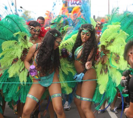 It rained on their parade but that did not dampen the spirits of these revellers, who were among those came out to fete in their colourful costumes for the inaugural Guyana Carnival yesterday. (Terrence Thompson photo)