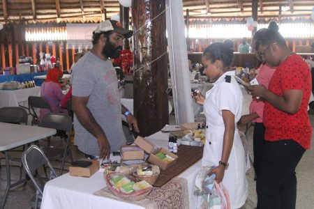 These patrons were yesterday considering gift items for their mothers, at the Food for the Poor’s ‘Mother’s Mega Market Day’ at the Umana Yana in Kingston. The event was hosted as a fundraiser and gave patrons the opportunity to pick out a gift for Mother’s Day. (Terrence Thompson Photo) 