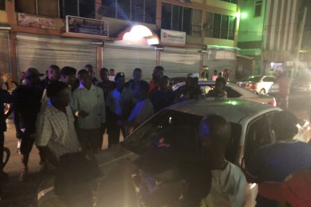 A crowd of public spirited persons surrounding the taxi last night on Regent Street in a bid to prevent the taxi driver from trying to flee the scene again 