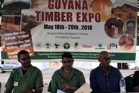 Commissioner of the Guyana Forestry Commission James Singh (centre), along with the Manager of the Forest Products Development Marketing Council of the GFC Kenny David (left) and one of the exhibitors at yesterday’s press conference at the Guyana National Stadium, Providence. 