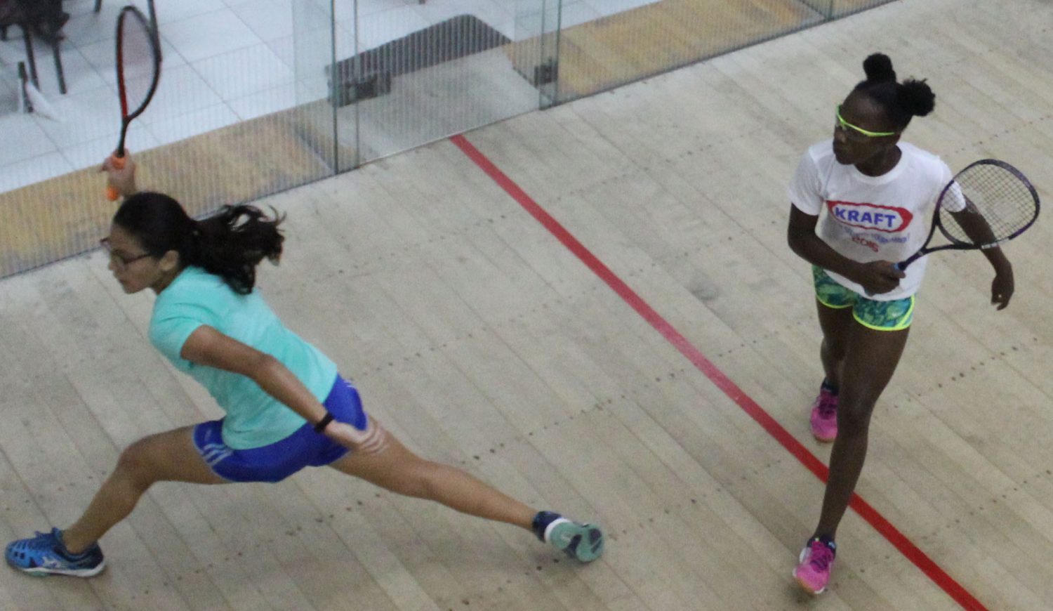 Madison Fernandes (left) is at full stretch as she strives to retrieve a well-placed ball from Abosaide Cadogan during their match in the Woodpecker Products Junior Nationals Squash Tournament last evening at the Georgetown Club. Cadogan won in straight sets 12-10, 11-7, 12-10. (Royston Alkins photo)
