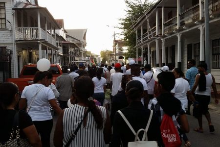 Persons at a march in Suriname yesterday walk in solidarity with families who were affected by the piracy attack.