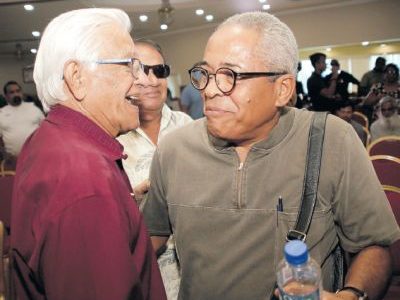 Former prime minister Basdeo Panday, left, and former Port-of-Spain mayor Louis Lee Sing after the open forum hosted by Mickela Panday at Gaston Courts, Gaston Street, Lange Park, Chaguanas on Sunday.