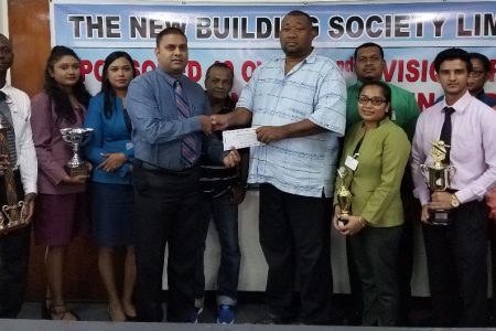 BCB President Hilbert Foster (right) receives the sponsorship cheque from NBS Regional Manager Rana Persaud.
