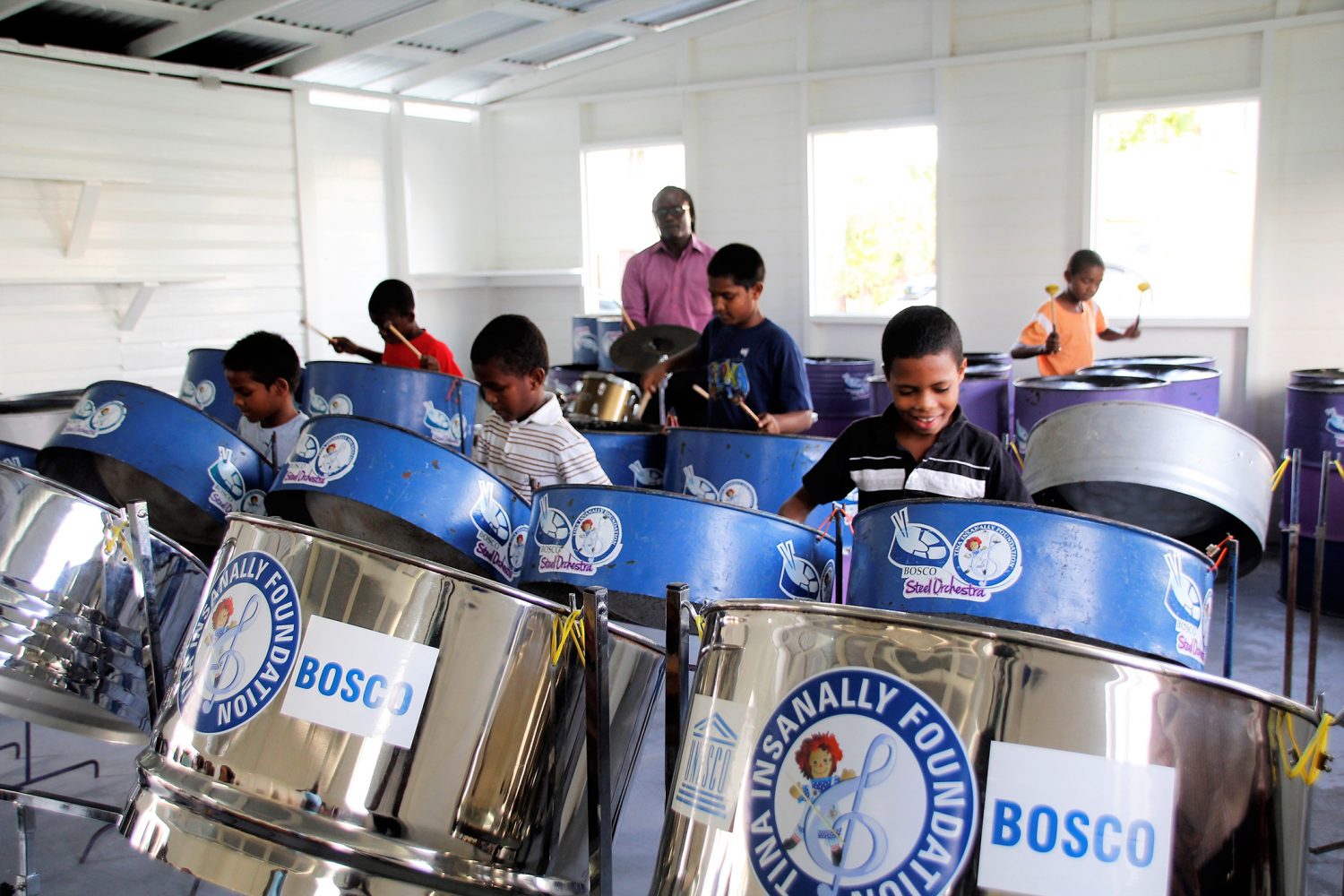 Members of the St. John Bosco Steel Orchestra showcasing their talent on the pans (Ministry of Education photo)