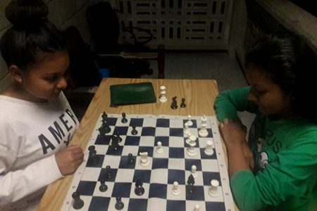 Chess sisters! Nellisha, 16 (left) and Waveney Johnson, 17, enjoying a game of chess. The girls are students of Christ Church Secondary School and reside in Orealla. They learnt their chess in Orealla before coming to Georgetown. Nellisha is a member of the chess team that will represent Guyana at the 2018 Chess Olympiad in Batumi, Georgia, in September.