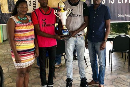 Sparta Boss representative Courtney Britton (2nd from left) and Bent Street coach Troy Lambert (3rd from left) posing with the trophy alongside Petra Organization representative Jackie Boodie (left) and Colin Stuart of Top Brandz Distributors.