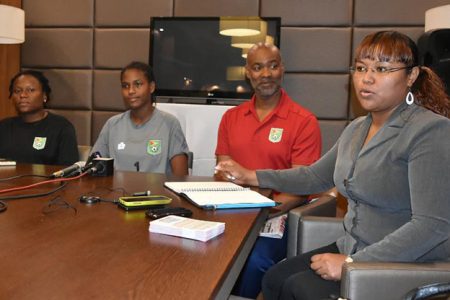 Lady Jaguars Head-Coach Ivan Joseph (2nd from right) posing for a photo opportunity following the conclusion of a pre-match press conference held at the Ramada Hotel. Alongside his recently appointed tactician is Goalkeeper Natalie Nedd (3rd from right) and Assistant Coach Akilah Castello (4th from right) Also in the photo is GFF PRO Debra Francis (right)
