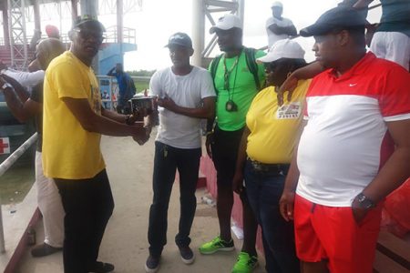 USA based Guyanese, Coach Kenrick Smith gifted a quantity of stopwatches to coaches to help aid in the development of the sport during the Independence Relay Championships on Sunday at the National Track and Field Centre. Above coach Sham Johnny receives the equipment from Smith.