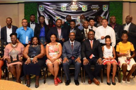The respective winners and attendees at the inaugural Guyana Football Federation Awards Ceremony Friday night pose with their spoils at the conclusion of the ceremony.
