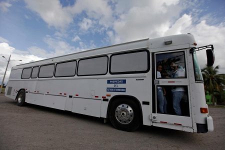 A bus carrying deportees, 17 Honduran adult women, as well as 12 girls and nine boys, aged between 18 months and 15 years, according to the Honduran government, from the U.S. leaves the international airport in San Pedro Sula, northern Honduras, July 14, 2014. REUTERS/Jorge Cabrera/File Photo