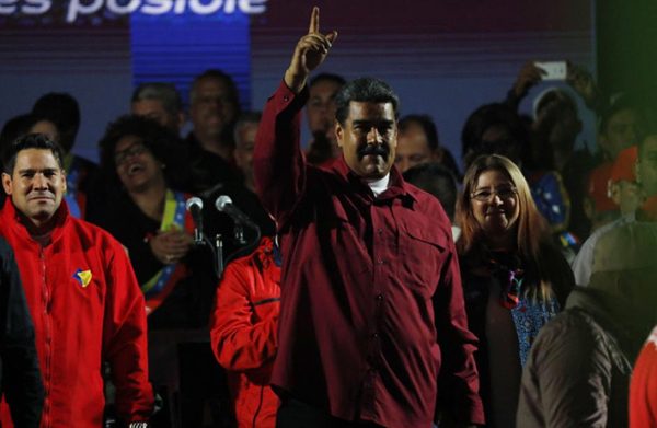 Venezuela’s President Nicolas Maduro raises a finger whiles surrounded by supporters as he speaks during a gathering after the results of the election were announced (Reuters photo)