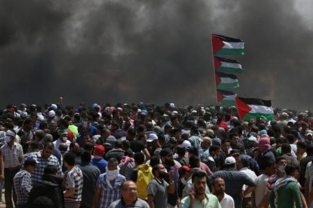 Palestinian demonstrators gather during a protest against U.S. embassy move to Jerusalem and ahead of the 70th anniversary of Nakba, at the Israel-Gaza border in the southern Gaza Strip May 14, 2018. REUTERS/Ibraheem Abu Mustafa