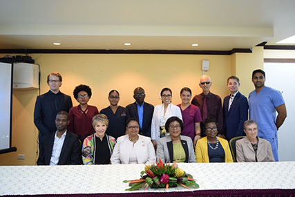 Minister of Public Health, Volda Lawrence (seated third from left) and Minister of Public Telecommunications, Catherine Hughes (seated fourth from left) pose with GPACC Director, Dr. Debra Isaac (seated second from left), High Commission of Canada Charge d’Affaires, Jan Sheltinga (seated at right) and GPHC health care providers, administrators and others who were a part of the production of the PSA. (DPI photo)