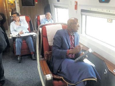 Prime Minister Dr Keith Rowley and the T&T delegation, Minister in the Office of the Prime Minister Stuart Young, left and Foreign Affairs Minister Dennis Moses travel by train from Beijing to Shanghai as they continue their official visit in China on Wednesday. 
