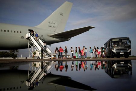 Venezuelan refugees board a Brazilian Air Force plane, heading to Manaus and Sao Paulo, at Boa Vista Airport, Brazil May 4, 2018. REUTERS/Ueslei Marcelino