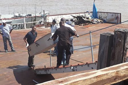 One the bodies being taken to a mortuary after being retrieved from the Wai Wai Bank by marine guards.