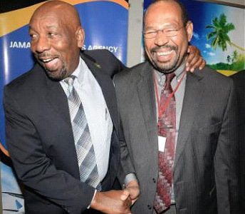 Rudyard Spencer (left), state minister for national security, shares a joke with Earl Harris, assistant director of strategic services for CARICOM Implementation Agency for Crime and Security, at the 19th annual staging of the CARICOM Chiefs of Immigration and Comptrollers of Customs, held at The Jamaica Pegasus hotel in New Kingston on Monday.
