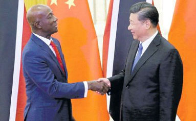 China’s President Xi Jinping, right, greets Prime Minister Keith Rowley at the Great Hall of the People in Beijing, China on Tuesday. PICTURE AP