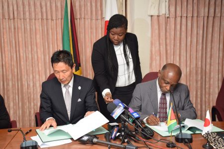 Minister of Foreign Affairs, Carl Greenidge (right) and Ambassador of Japan to Guyana, His Excellency Mitsuhiko Okada (left) signing the grants.