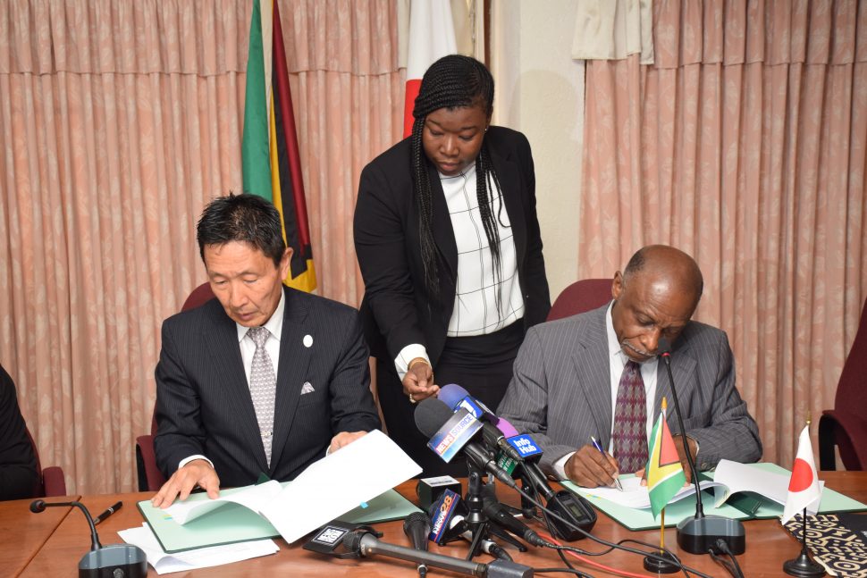 Minister of Foreign Affairs, Carl Greenidge [right) and Ambassador of Japan to Guyana, His Excellency Mitsuhiko Okada (left) signing the grants.