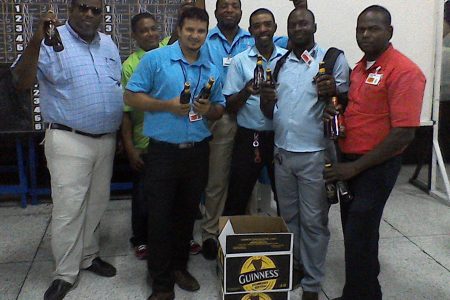 The victorious Pre-Sellers unit posing with their spoils, following victory over Trisco and Central Service in the Banks DIH Limited ‘President’s Cup’ Inter-Department Domino Championship
