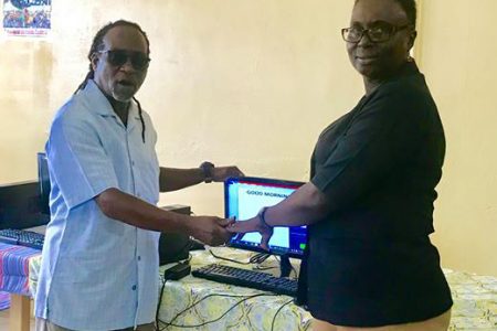 DEMCAR Communications and Marketing Inc., a United Kingdom/Guyana-based online company yesterday donated two computer systems to the Agricola Industrial Arts Centre. In photo, Colin Beckles (left), a past student and now a United Kingdom-based Guyanese and co-proprietor of the company, makes the presentation to the school’s Principal Deborah Parker. During the simple presentation ceremony, Beckles charged the students to use the computer systems to advance their studies, to push themselves and grab every opportunity which is presented to them. The donations were made possible through the company’s foundation, KIDS NEED DADDY (KNDY), which has the goal of ensuring that everything possible is done to alleviate poverty and to provide sustainable livelihoods for young people, while placing special emphasis on young single mothers and their offspring. (David Papannah photo)