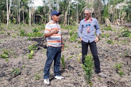 Minister of Business with responsibility of Tourism, Dominic Gaskin and Moraikobai Village Toshao, Adrian Colin at the proposed site for the construction of the Eco-Lodge.