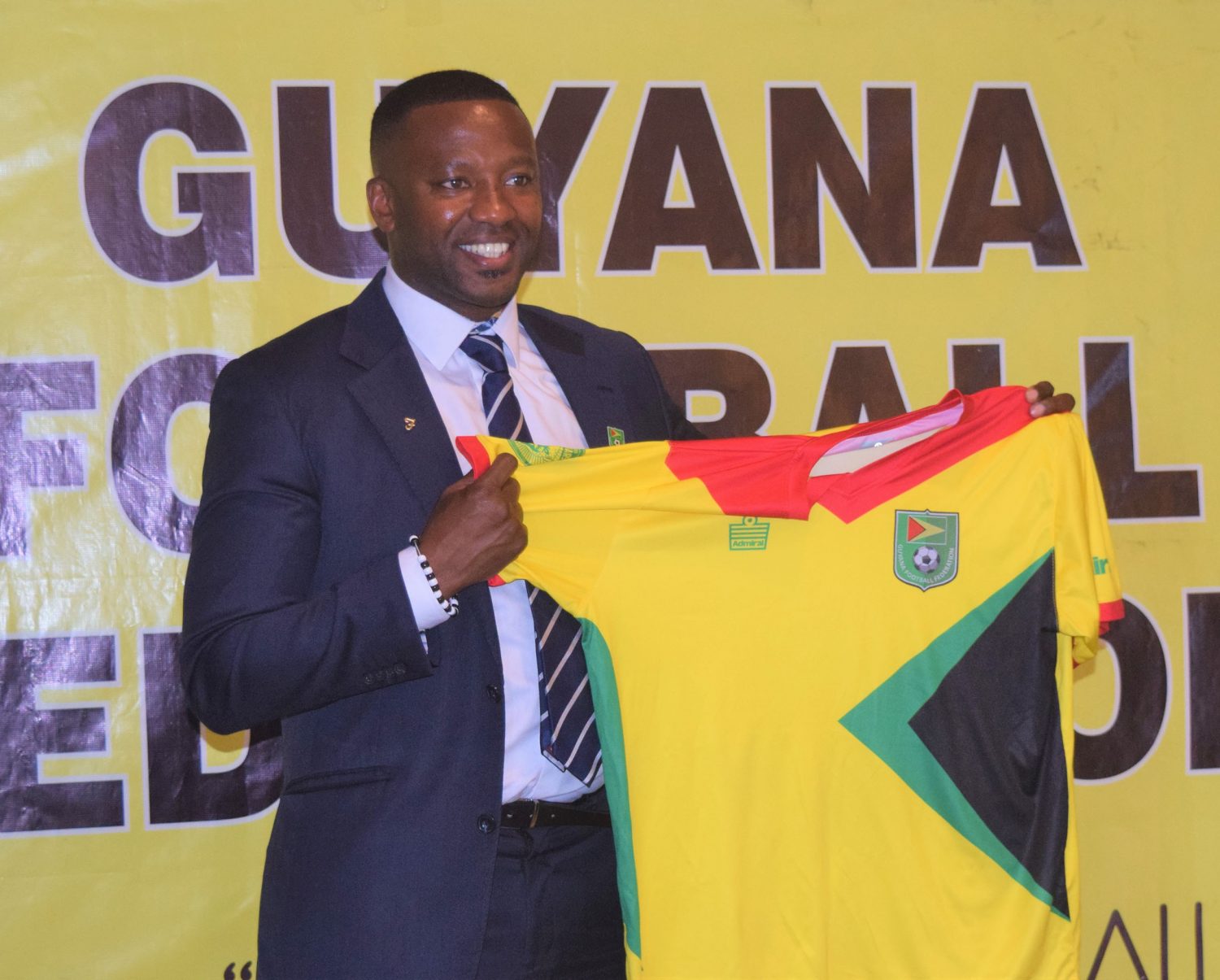   Newly appointed Golden Jaguars Head-Coach Michael Joseph, displaying the symbolic Golden Jaguars Jersey following his presentation to the media and public yesterday at the SleepIn Hotel and Casino 