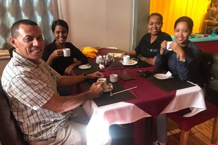 Employees of Magua Risk Consulting and Kronoco Safety Solutions enjoying chai tea at the Aagman Restaurant as they await their meals ordered from the GRW menu on Friday.