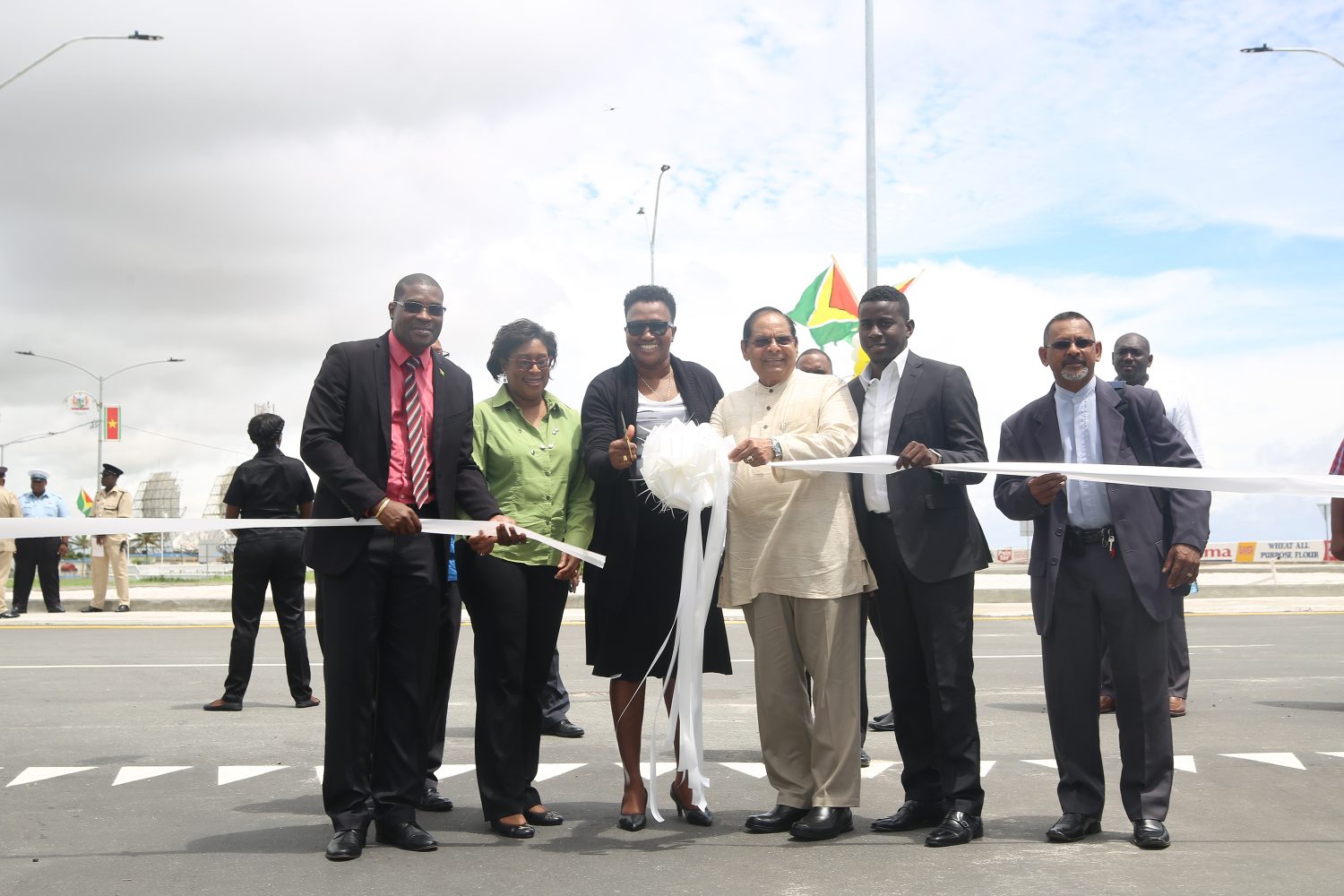 Minister within the Ministry of Public Infrastructure Annette Ferguson (third, from left) cutting the ribbon to formally open the Kitty roundabout yesterday, along with Minister of Public Infrastructure David Patterson (left), Minister of Public Telecommunications Cathy Hughes (second, from left), Prime Minister Moses Nagamootoo (third, from right) and Deputy Mayor of Georgetown Akeem Peters (second, from right). (Photo by Terrence Thompson)

