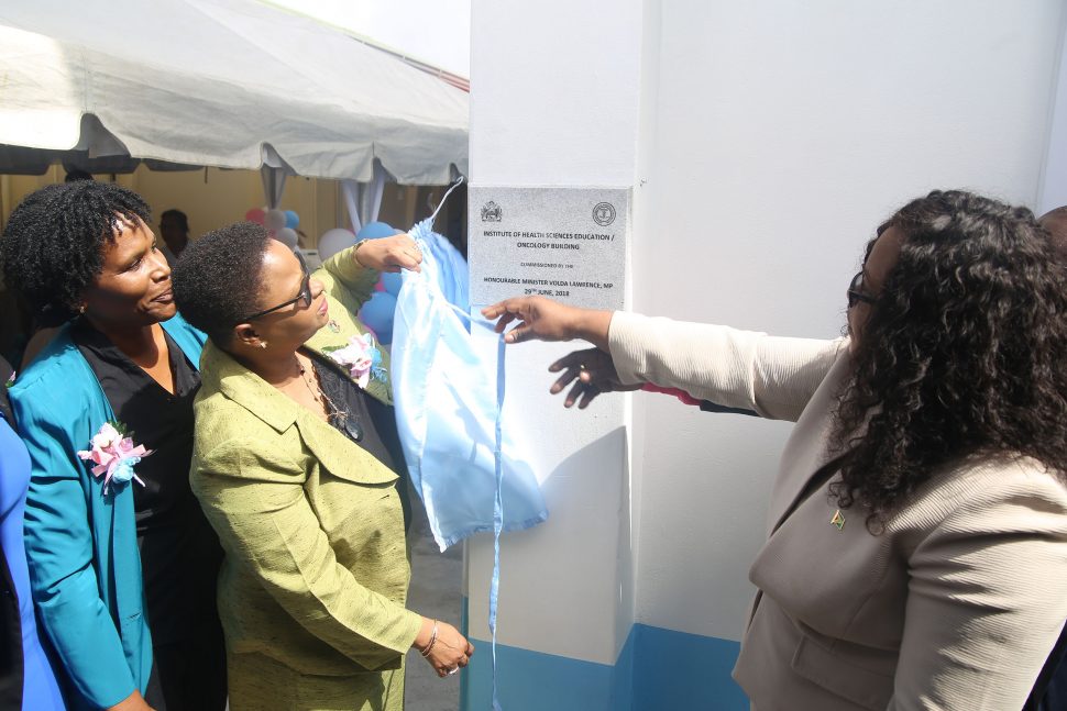 Minister of Public Health Volda Lawrence (second, from right) and Junior Health Minister Dr. Karen Cummings () as they unveiled the plague for the building which now houses the Institute of Health Science Education (IHSE) and the Oncology Department. (Photo by Terrence Thompson)