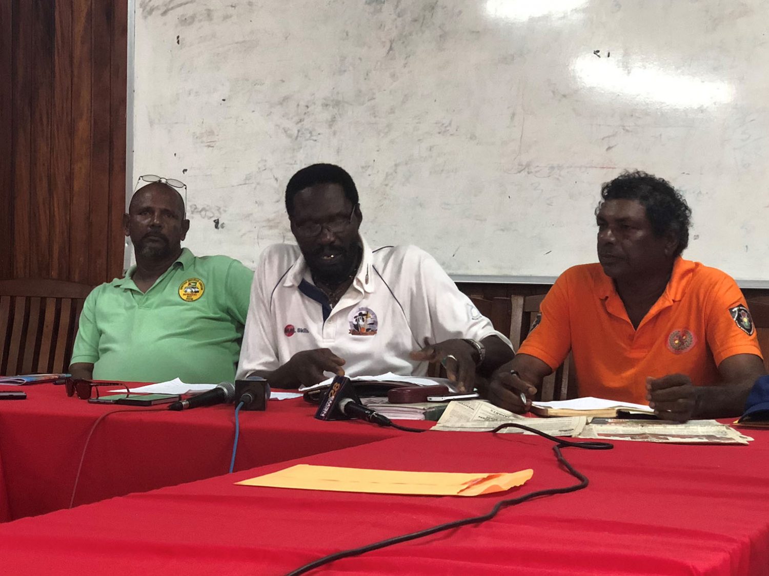 Head of the United Minibus Union Eon Andrews is flanked by Sookdeo Singh,(left), a minibus driver from the East Coast of Demerara and James Cowsil, (right), a minibus driver from the West Coast of Demerara, at yesterday’s press conference. 