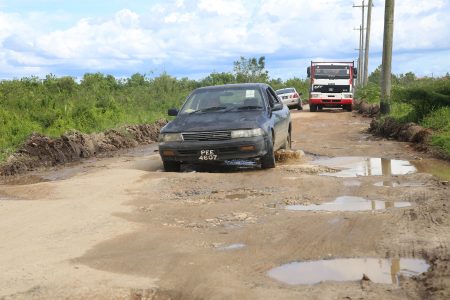 A car manoeuvring  through the Belle West Phase 2 access road, West Bank Demerara.