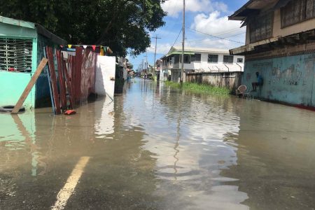  Streets in Albouystown were flooded yesterday following heavy rain around noon. This was a section of James Street.   (David Papannah photo)
