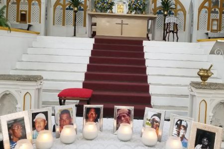 The photographs of victims of the Lindo Creek massacre at the Brickdam Cathedral yesterday. The tragedy took the lives of Cecil Arokium, Dax Arokium, Horace Drakes, Bonny Harry, Lancelot Lee, Compton Speirs, Nigel Torres and Clifton Wong.